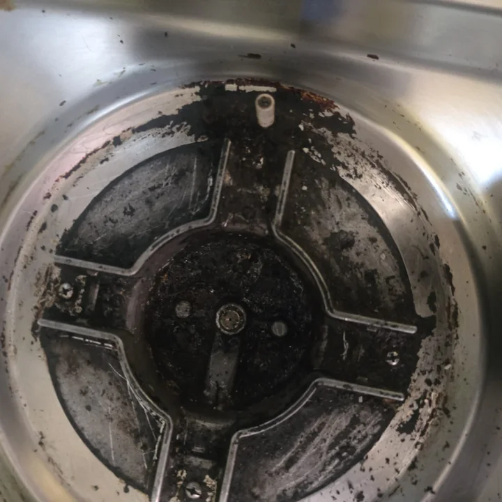 Top-loader wash tub with dirt built up under the pulsator
