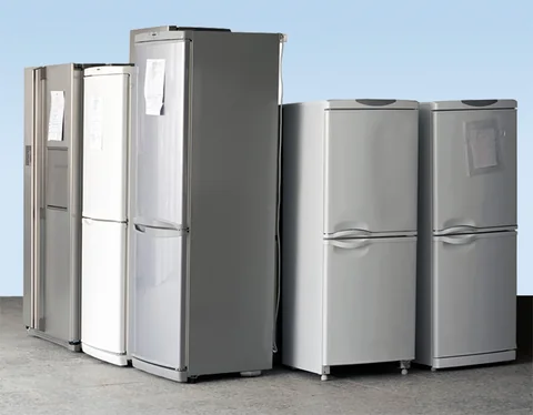 Row of fridges lined up in the workshop waiting for repair