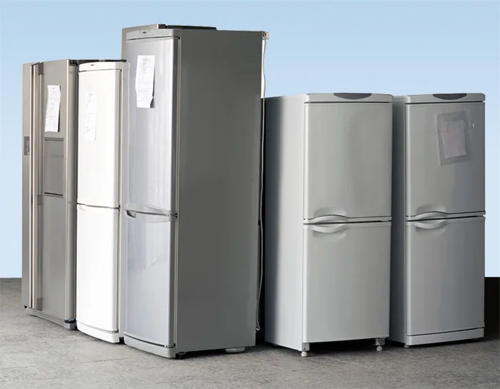 Row of fridges lined up in the workshop waiting for repair