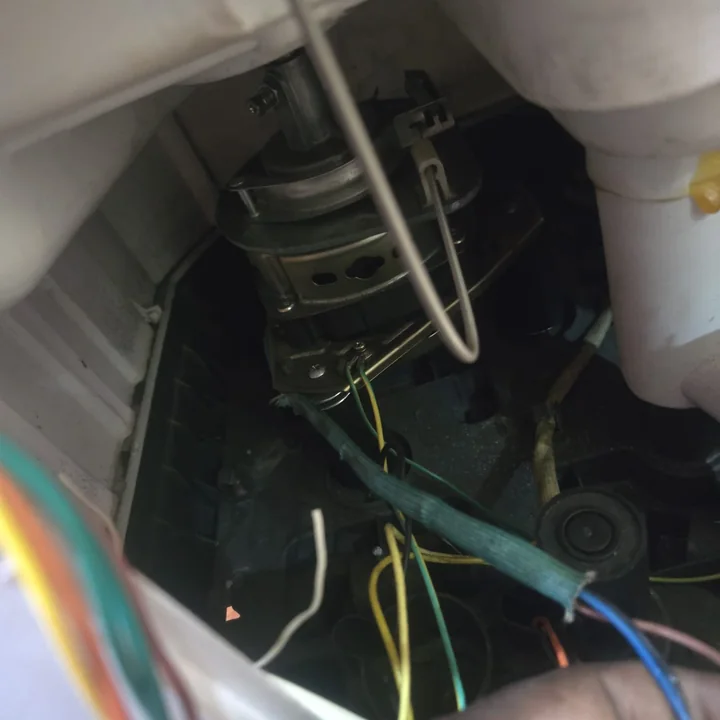 Washing machine motor and wiring seen from inside the cabinet