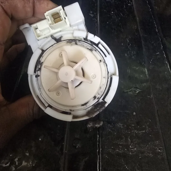 Washing machine drain pump impeller with dirt buildup